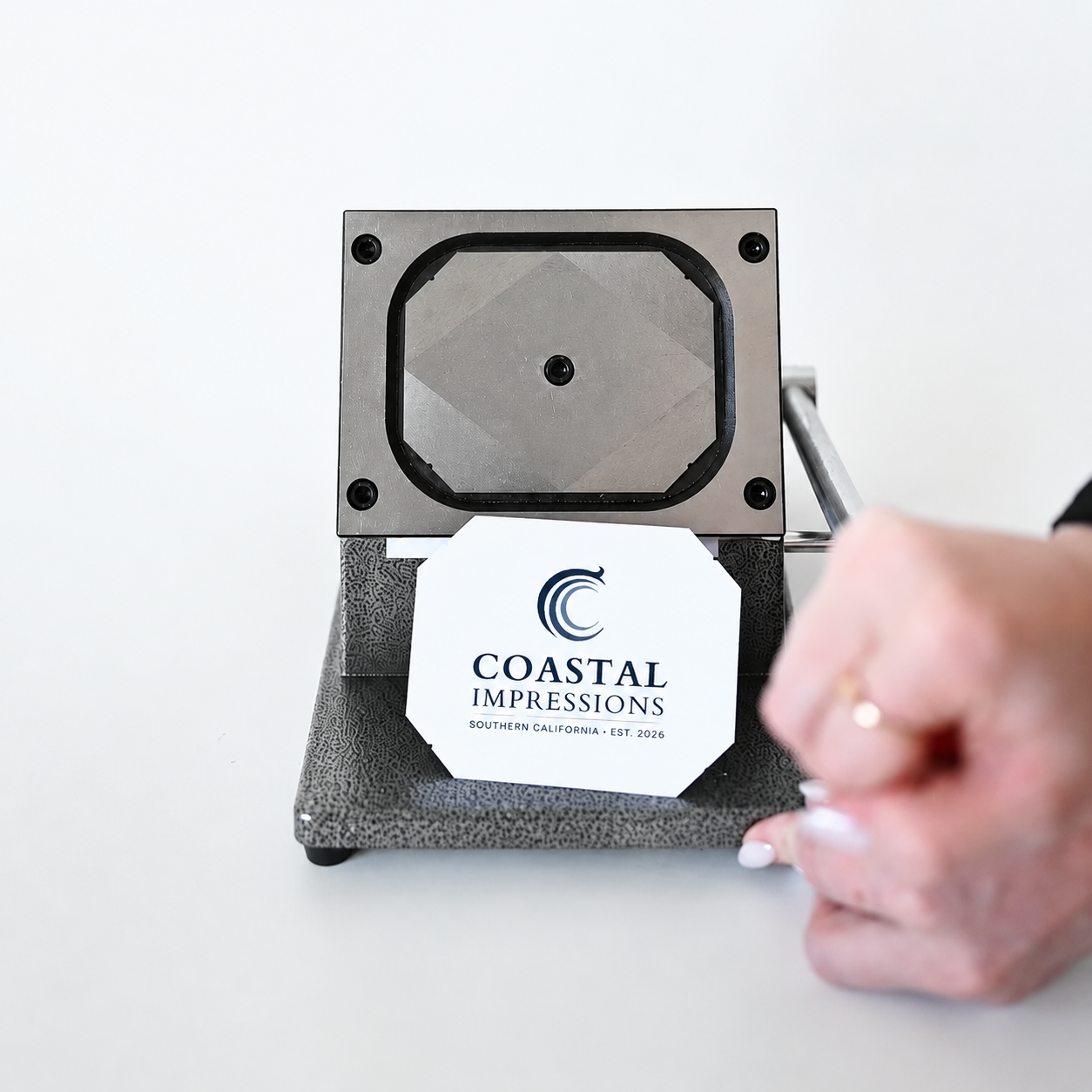Coastal Impressions photo magnet being handcrafted on a magnet press